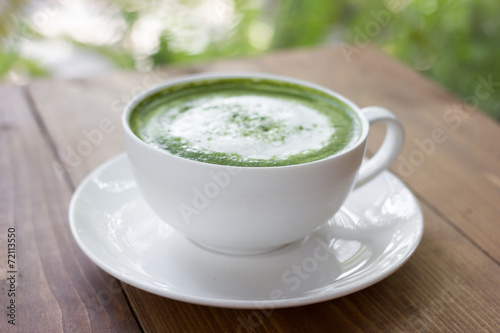 Matcha green tea latte beverage in glass.