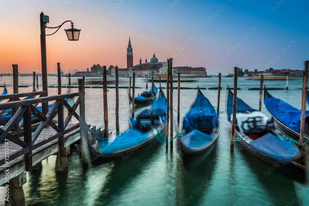 Swinging gondolas in Venice at sunrise