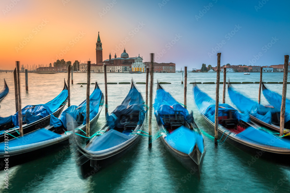 Blurred gondolas in Venice at dawn