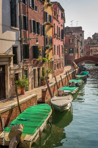 Few boats on a canal in Venice