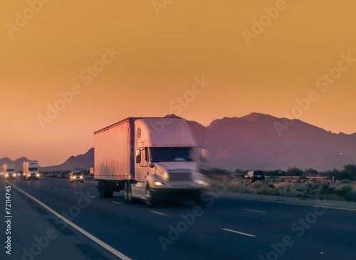 Truck and highway at sunset - transportation background