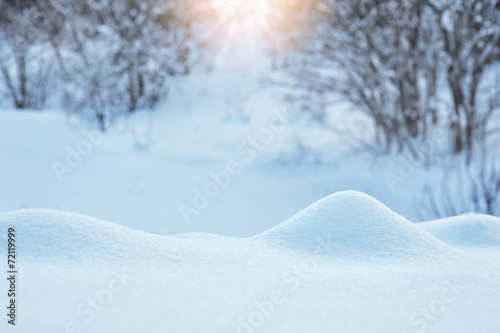 Winter background with a snowdrift and sun © timonko