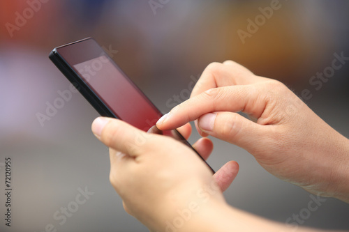 young woman hands use cellphone in city 