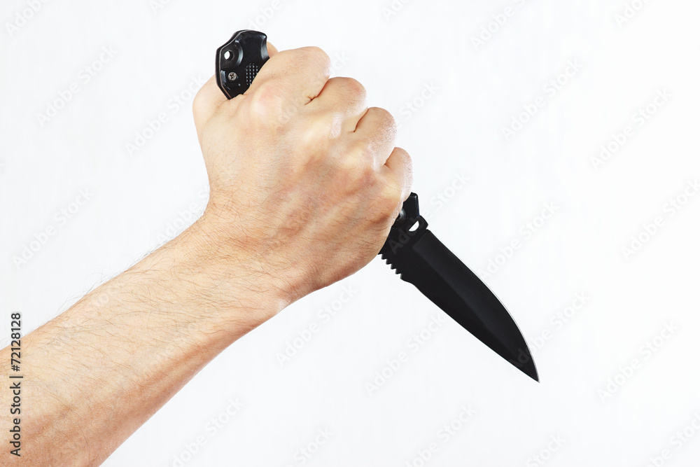 Obraz premium Hand with a combat knife on a white background