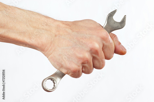 Hand of serviceman with a wrench on a white background