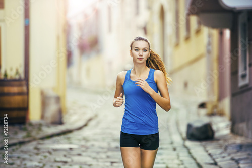 Young woman running in city center