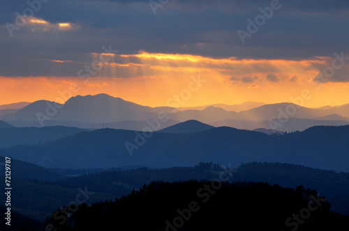 Sunset over color mountain silhouette. © TTstudio