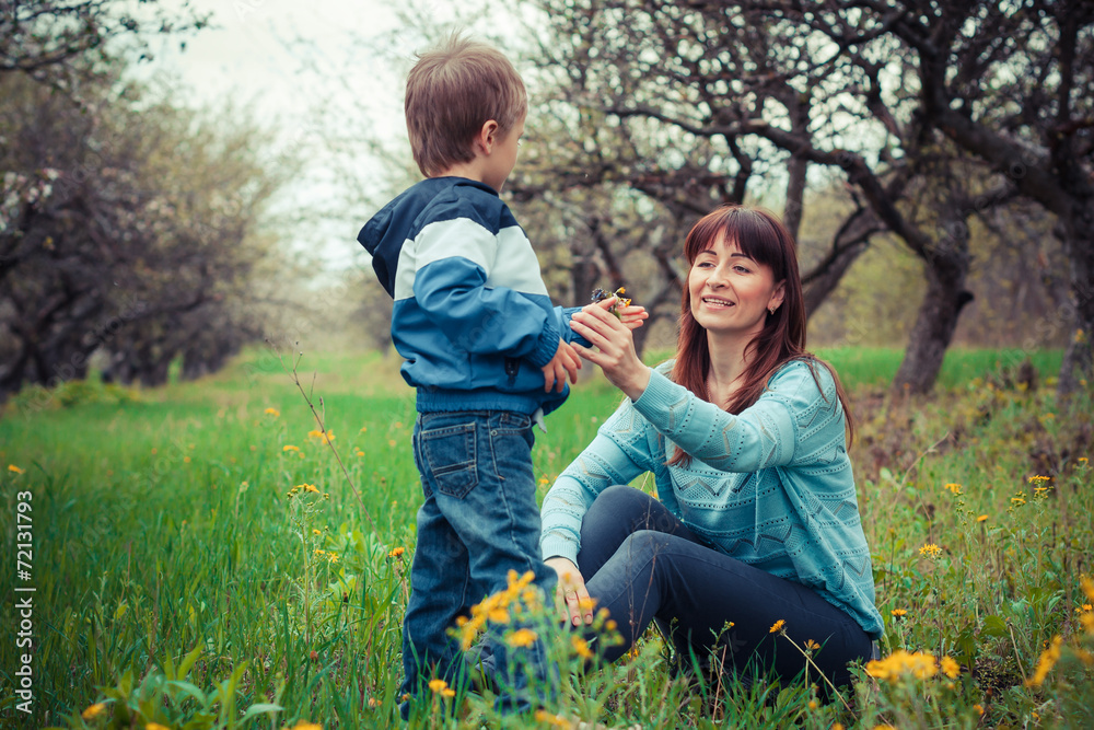 mother and son in the flowered garden mother and son in the flowered garden