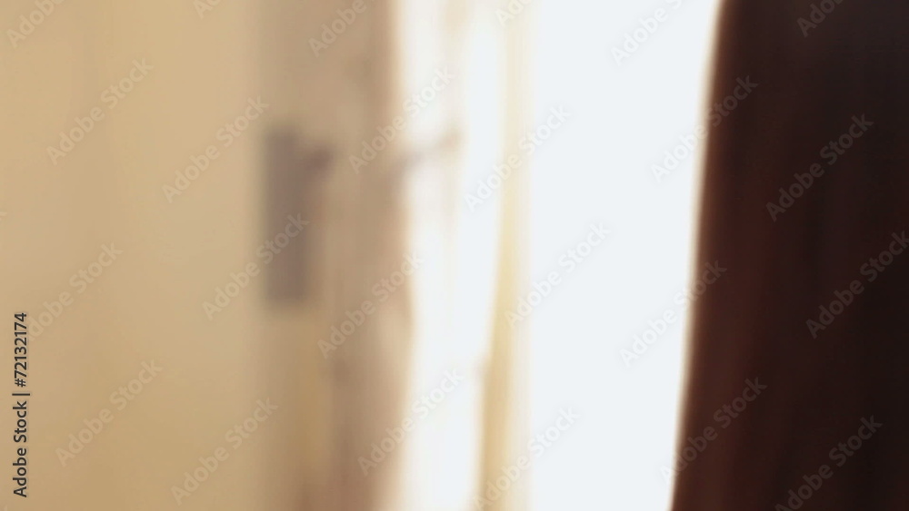 Confident beautiful woman passes by in the light of window Confident beautiful woman passes by in the light of window