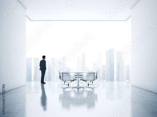 Businessman looking megalopolis through window © SFIO CRACHO