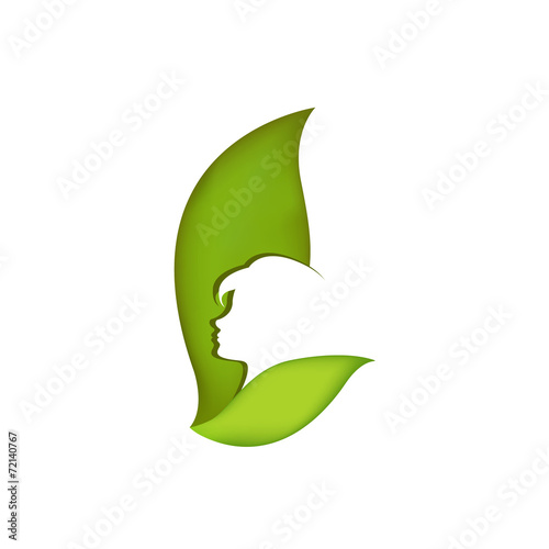Profile of a girl on a background of green leaves