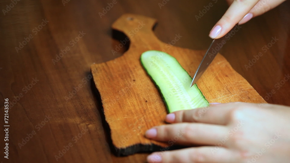 female hand making flower from strip of cucumber closeup double female hand making flower from strip of cucumber closeup double