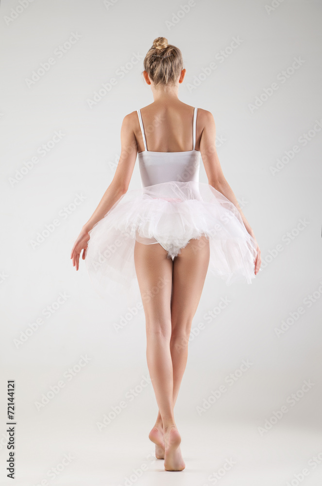 Naklejka premium Ballerina in classical tutu over white background