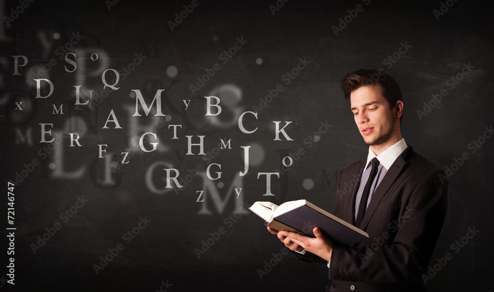Young man reading a book with alphabet letters Young man reading a book with alphabet letters