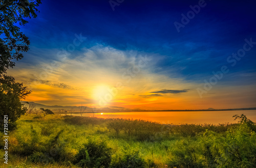 Landscape Sunrise-sunset reflection on calm lake Green