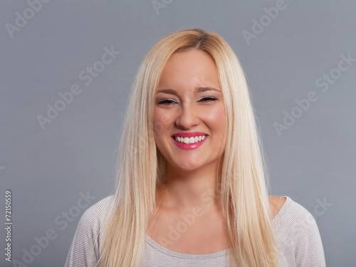 Portrait of beautiful young woman smiling. Studio shot.