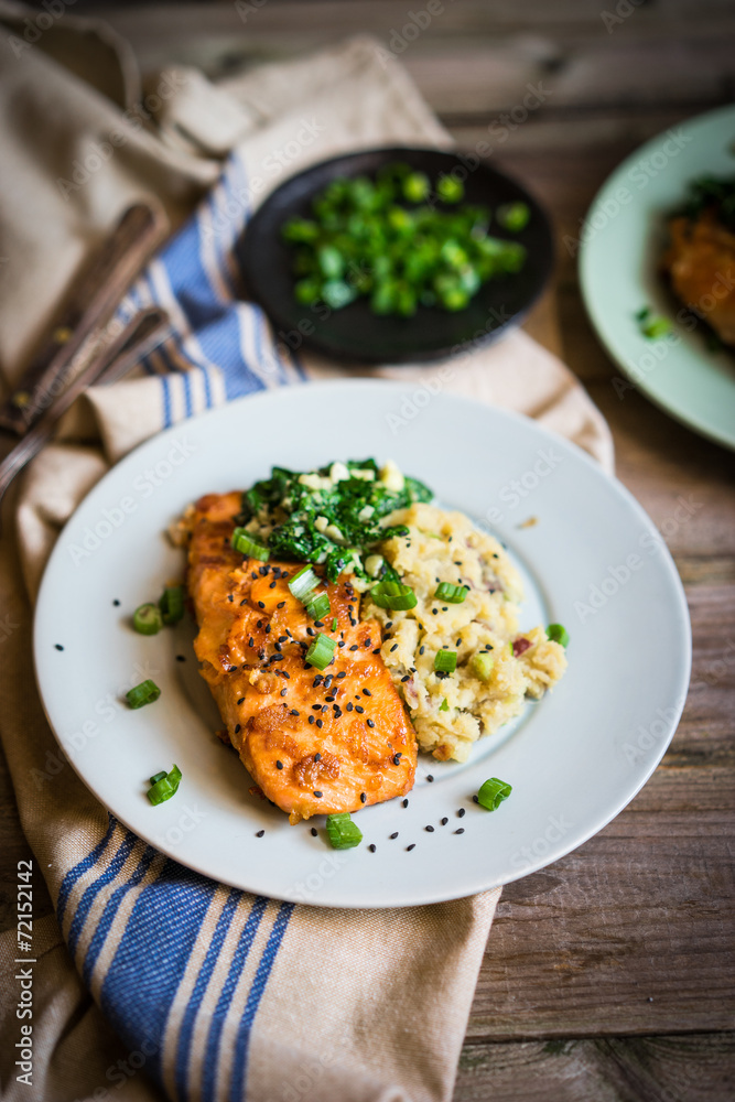 Salmon steak with mashed potatoes and greens