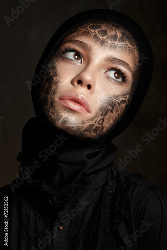 фотографія Young beautiful woman with faceart