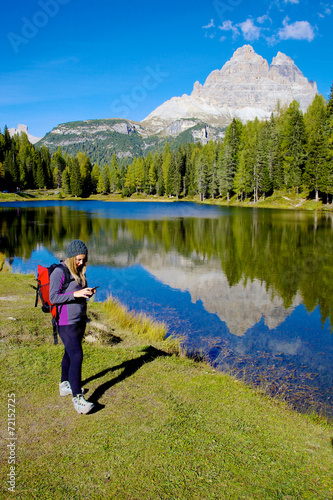 Woman while hiking checking map on cell phone