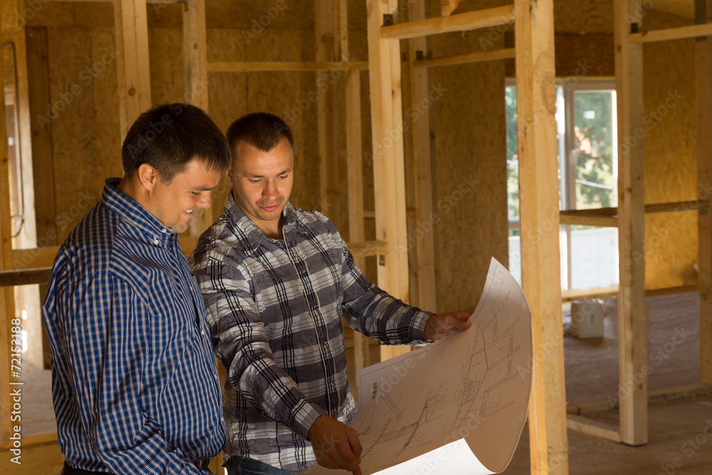 © kolotype - Two builders inside a half completed house © kolotype - Two builders inside a half completed house