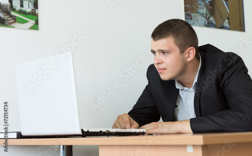 Serious Businessman Browsing Using Laptop