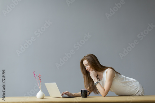 Young woman with laptop in ...