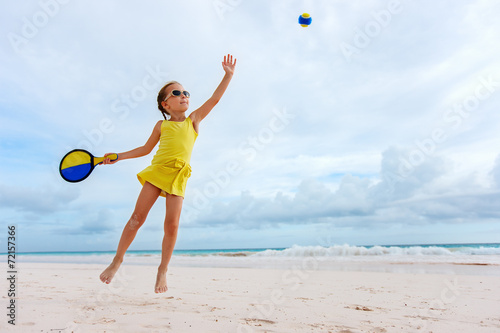 Little girl playing beach tennis © BlueOrange Studio