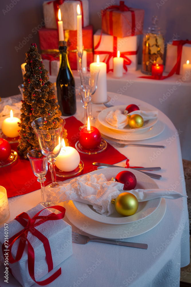 Christmas dishware on the white and red table Christmas dishware on the white and red table