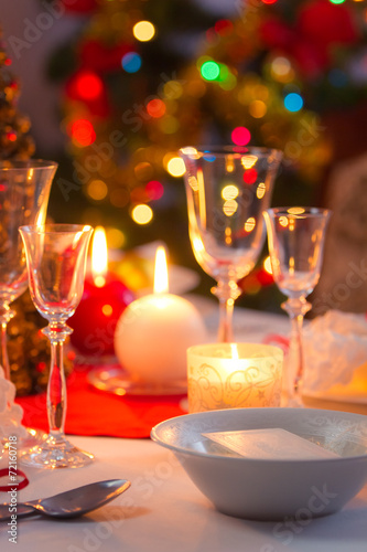 Candlelight, wafer and gifts on the Christmas table