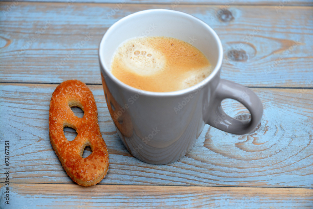 Fototapeta premium Koffie mok op oud hout met krakeling