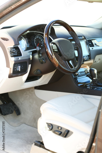 Interior view of car with beige salon and black dashboard © Africa Studio