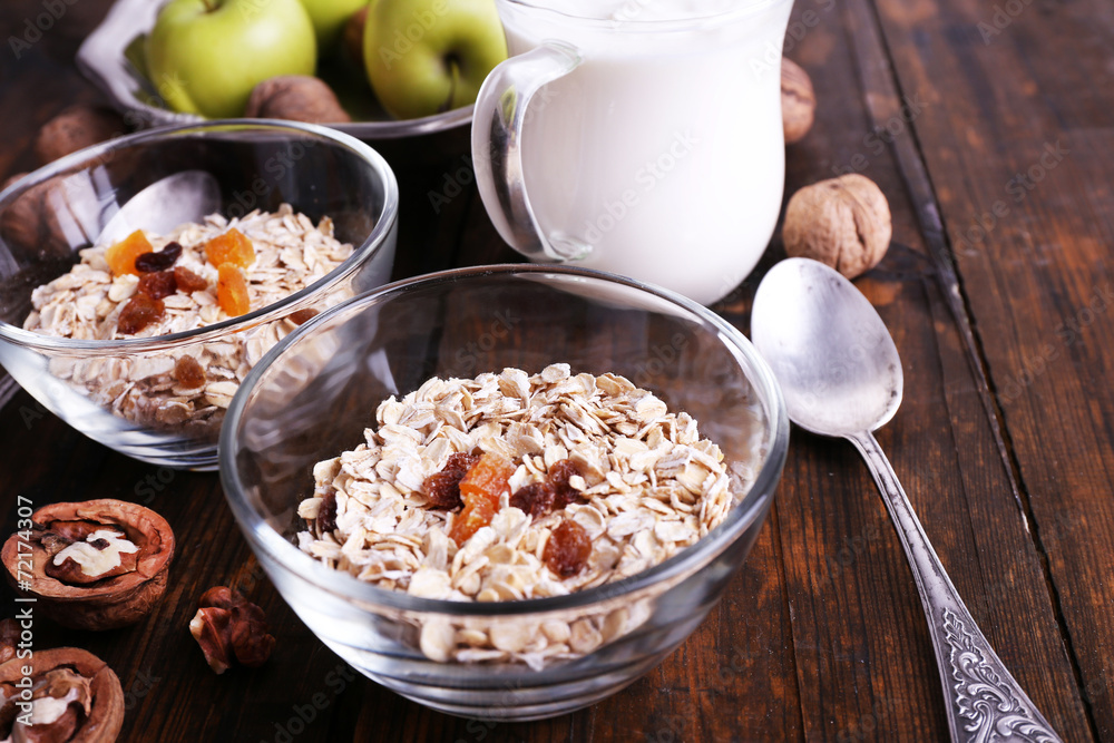 Oatmeal in bowls, yogurt, apples, dried apricots and walnuts Oatmeal in bowls, yogurt, apples, dried apricots and walnuts