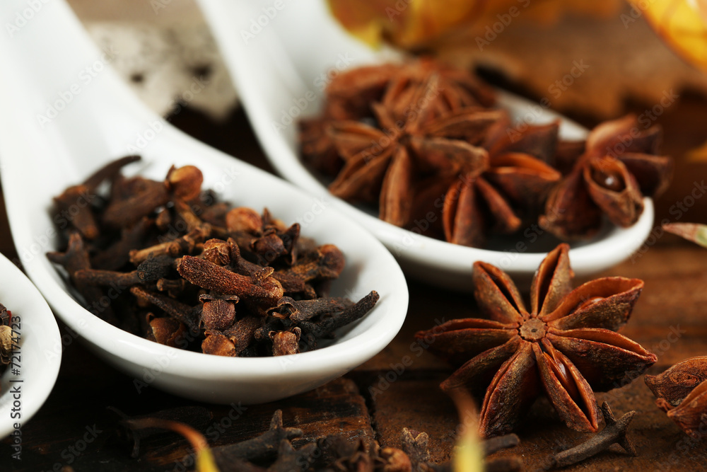 Different spices in spoons with yellow leaves Different spices in spoons with yellow leaves