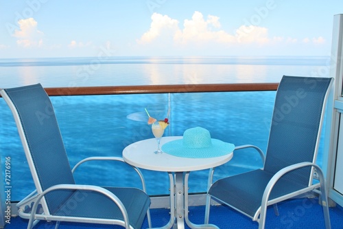 Cruise ship balcony chairs  table and tropical drink