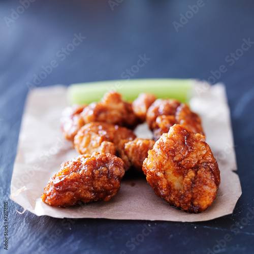 boneless barbecue chicken wings on slate table
