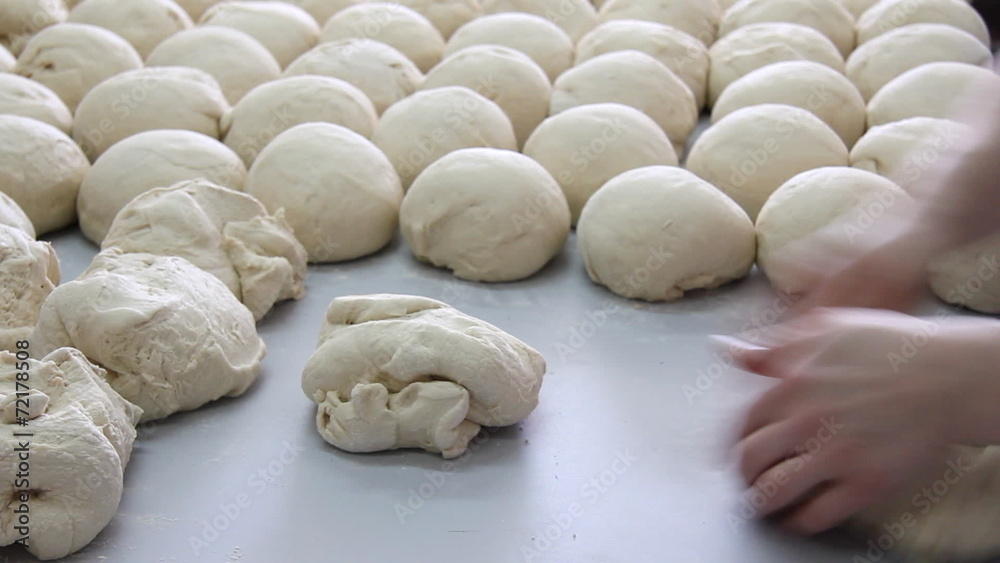 Baker kneading dough in a bakery Baker kneading dough in a bakery
