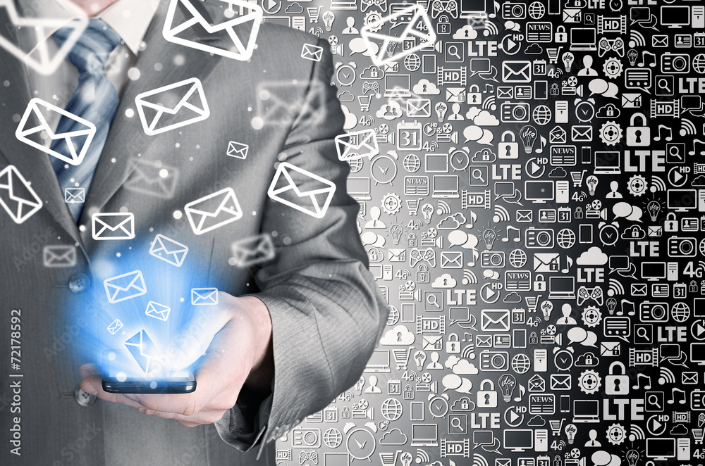 Business man holding smart phone and sending emails Business man holding smart phone and sending emails