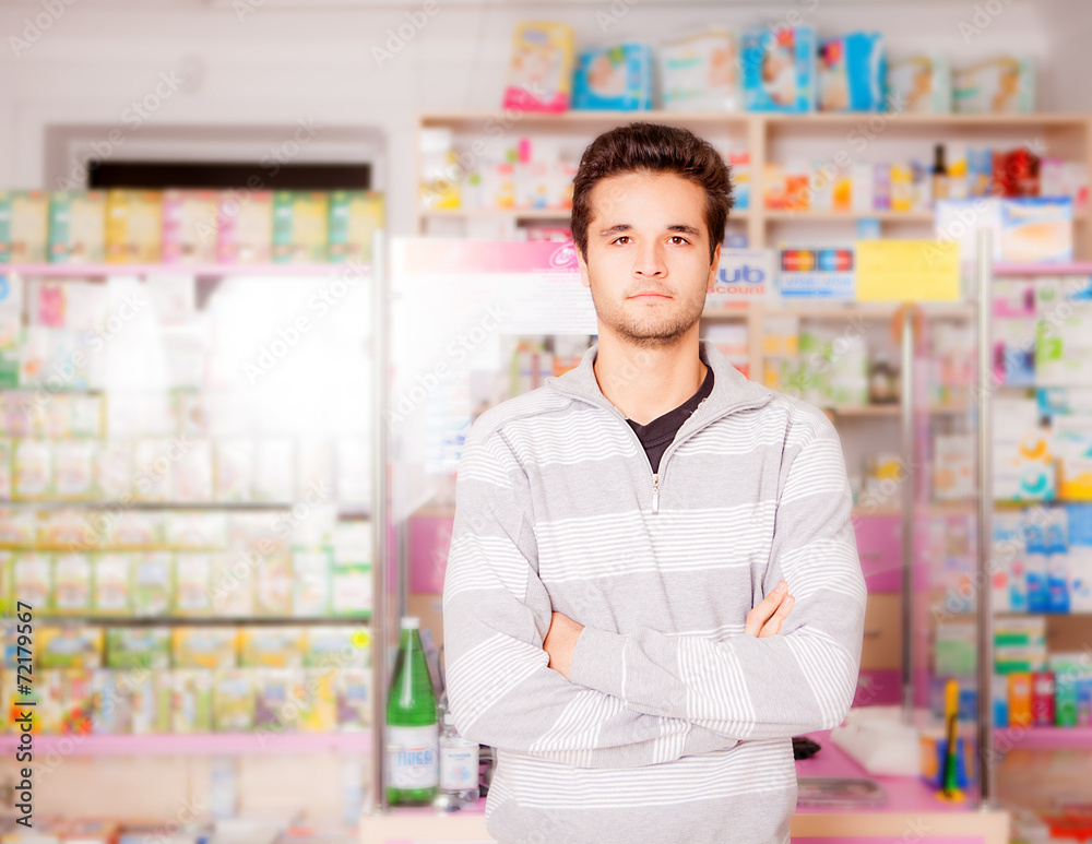 Handsome guy in front of pharmacy stand