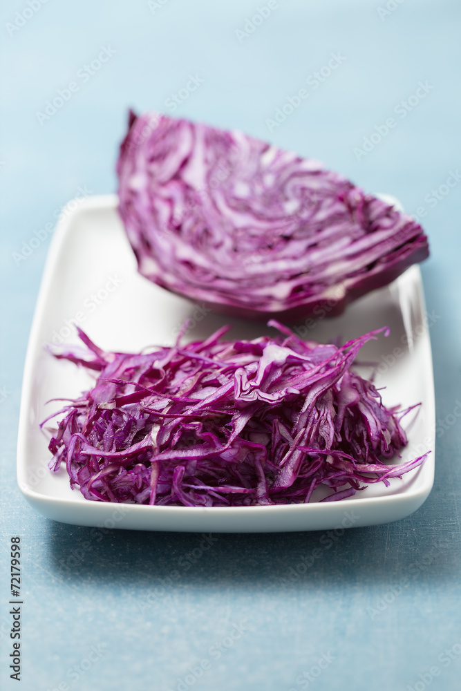 Obraz premium Shredded red cabbage on white plate