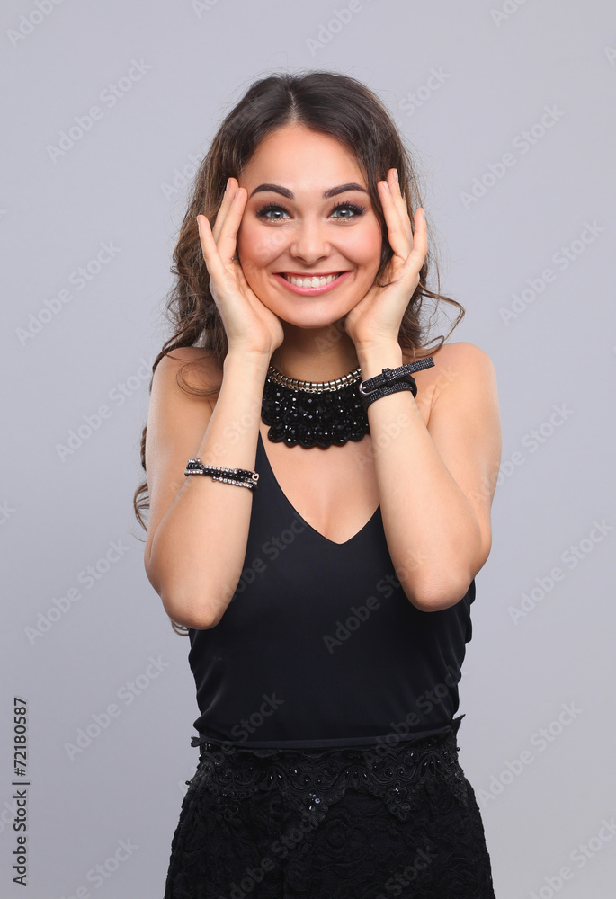 Portrait of a beautiful woman with necklace, isolated on grey