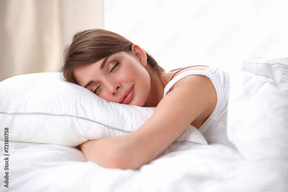 Beautiful girl sleeps in the bedroom, lying on bed Beautiful girl sleeps in the bedroom, lying on bed