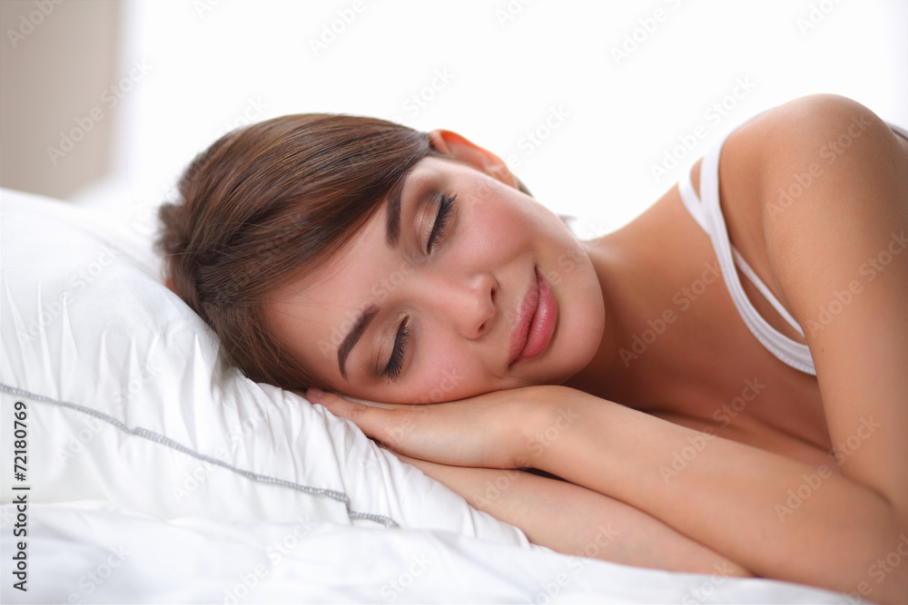 Beautiful girl sleeps in the bedroom, lying on bed Beautiful girl sleeps in the bedroom, lying on bed