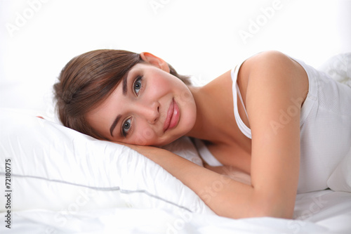 Beautiful girl lying in bedroom at early morning