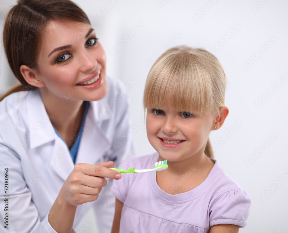 Dentist and little girl in the dentist office. Dentist and little girl in the dentist office.