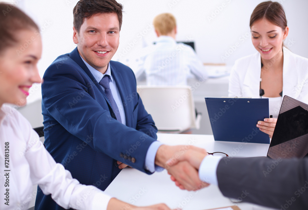 Business people shaking hands, finishing up a meeting Business people shaking hands, finishing up a meeting