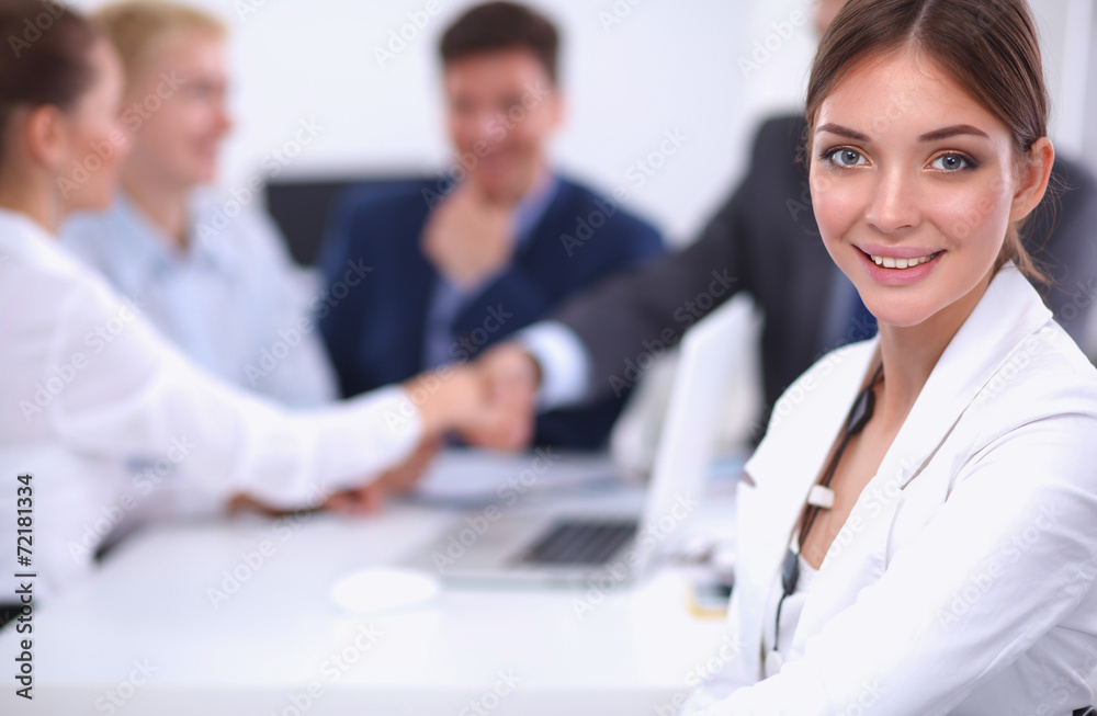 Beautiful young business people with colleagues discussing in Beautiful young business people with colleagues discussing in