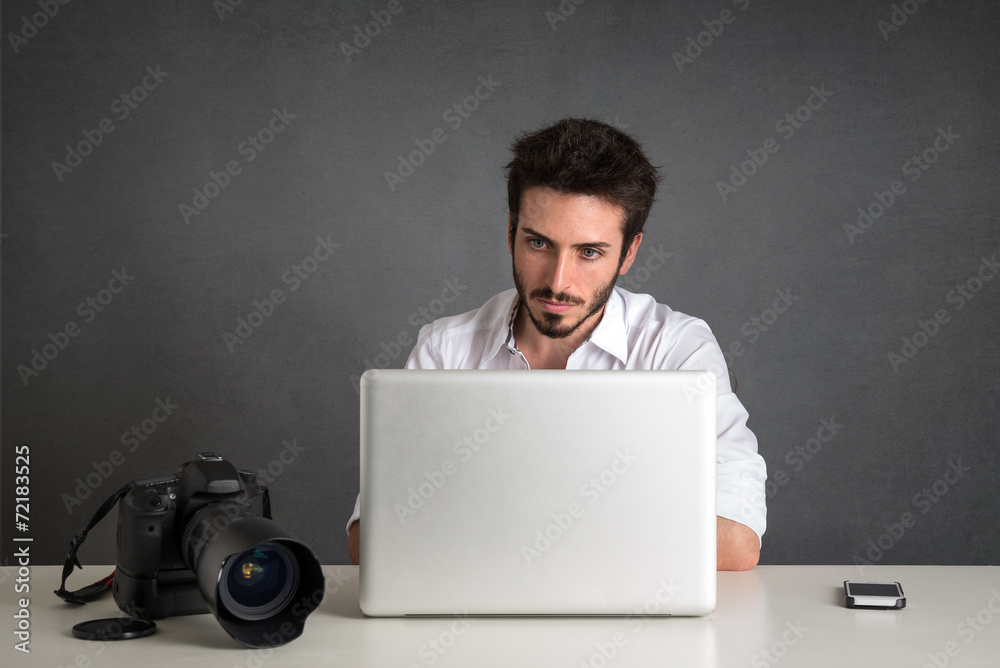 Man working with laptop portrait over dark grunge background. Man working with laptop portrait over dark grunge background.