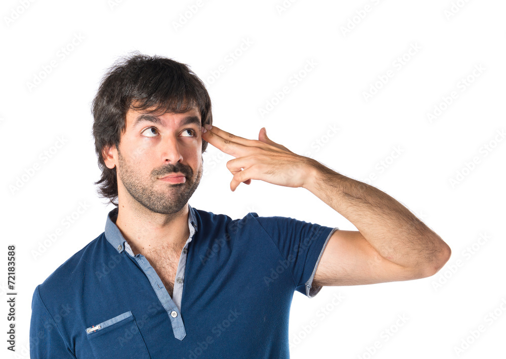 Man making suicide gesture over white background Man making suicide gesture over white background