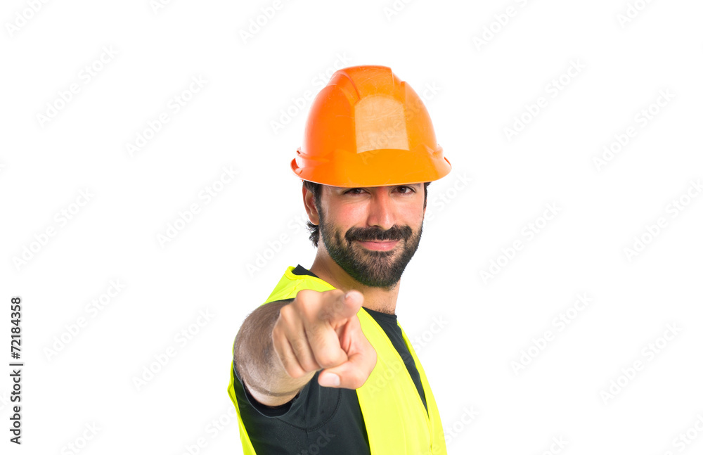 Workman pointing to the front over white background Workman pointing to the front over white background