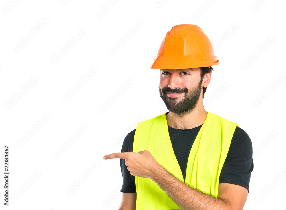 Workman pointing to the latertal over white background Workman pointing to the latertal over white background
